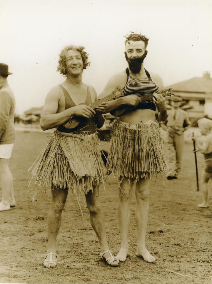 Dressing up - Two people dressed in grass Hula skirts