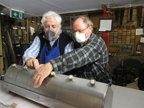 volunteers interacting with items from the museums collection